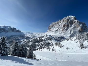 Ski slope Ciampinoi 5 in Selva Val Gardena Dolomites, part of the Sellaronda - View to Passo Sella and Sassolungo in winter